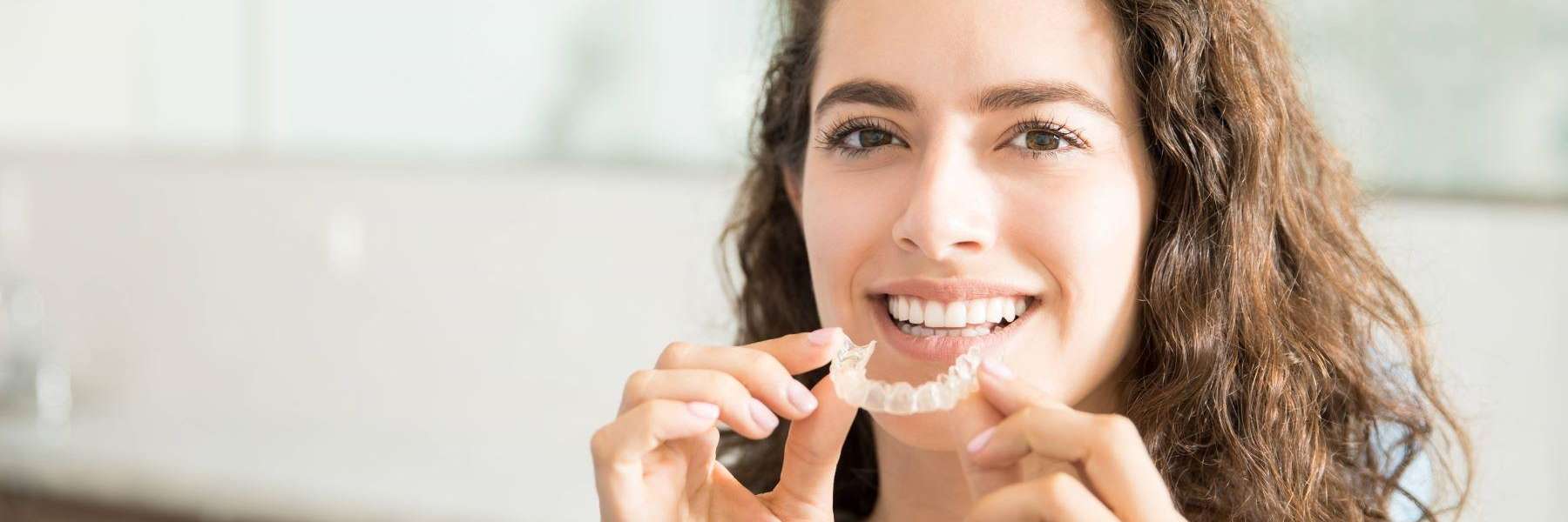 A woman holding a mouthguard | dentist in Jonesboro AR