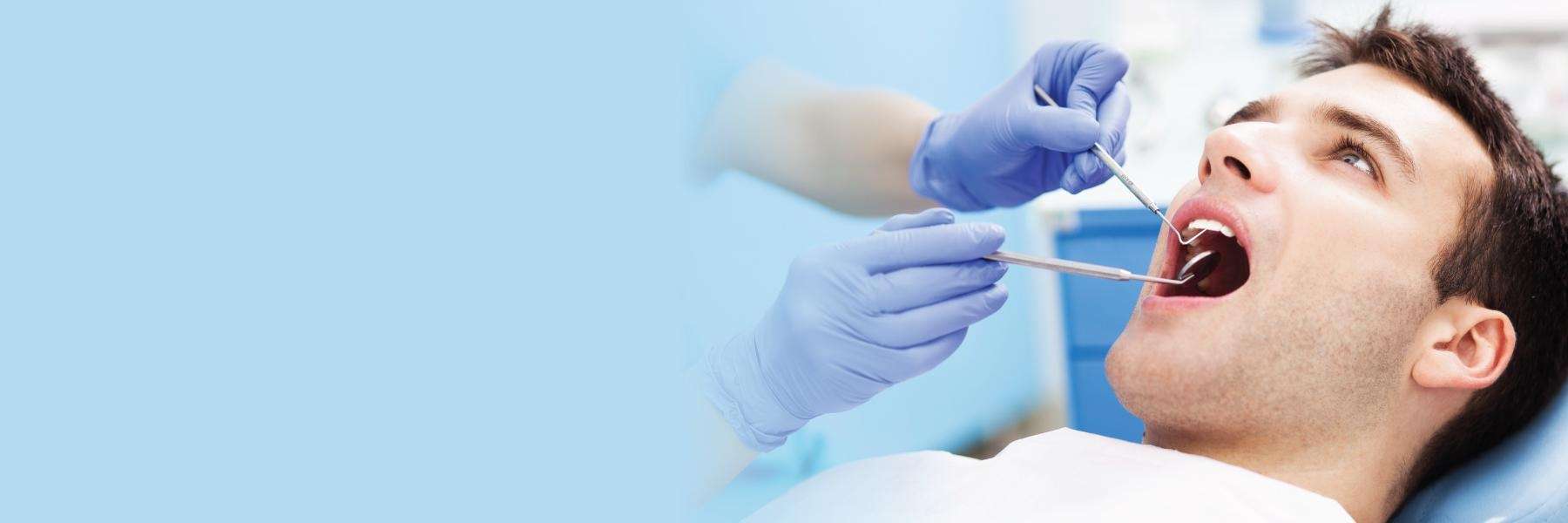 A man receiving a dental exam | Jonesboro dentist