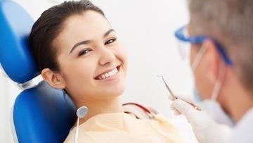 woman in dentist chair smiling | periodontal treatment jonesboro