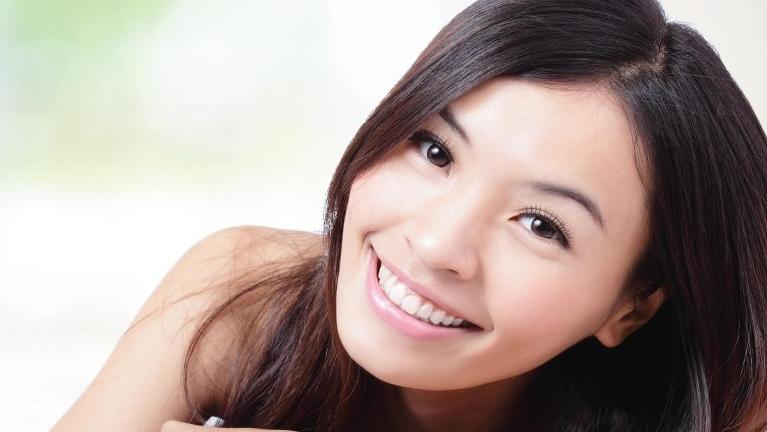woman smiling after dentist appointment in jonesboro