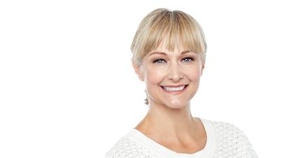 Woman Smiling in white sweater | Dentist in Jonesoro AR