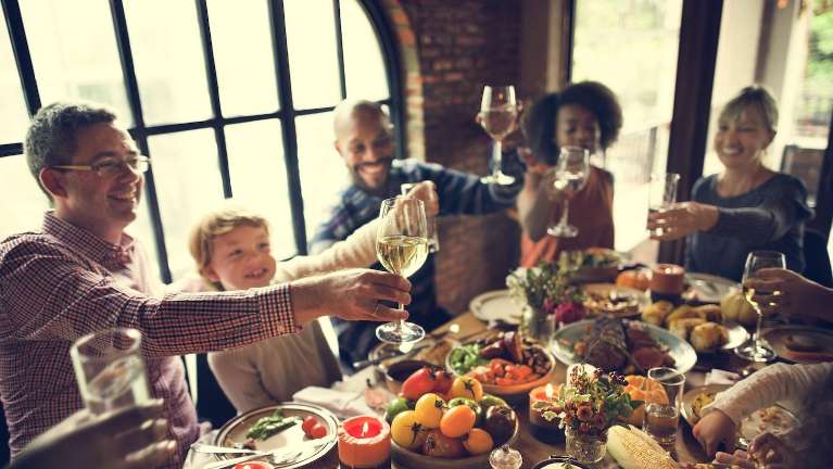 A group of friends and family having holiday dinner | dentist Jonesboro