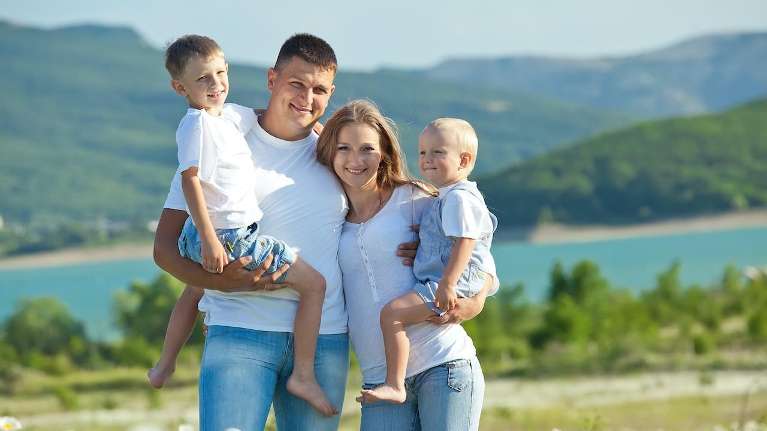 A family smiling by the lake | Jonesboro dentist