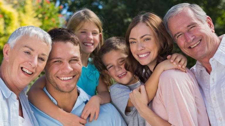 A smiling family at the park | Jonesboro dentist