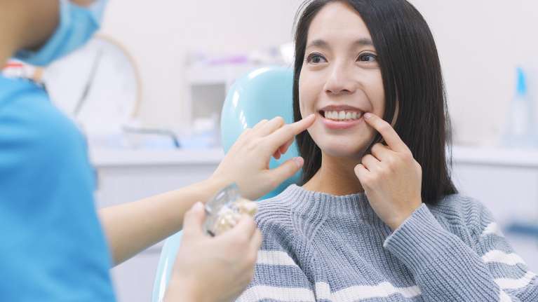 A woman being fitted for a mouthguard
