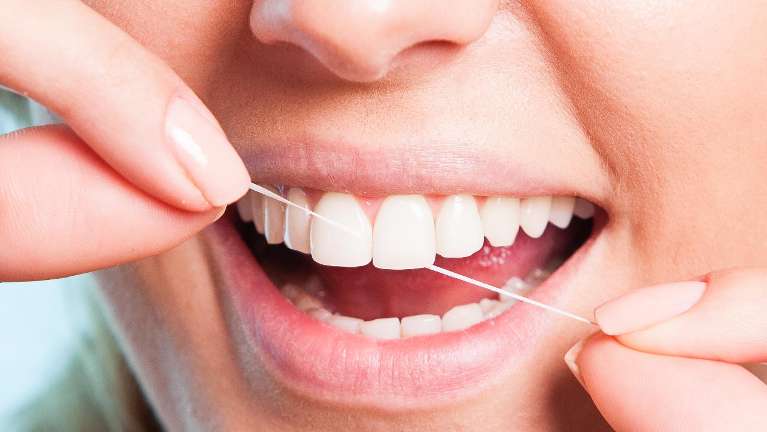 A woman flossing