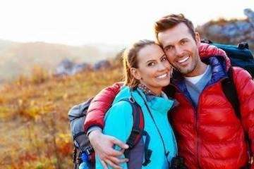 A smiling couple hiking | dentist Jonesboro