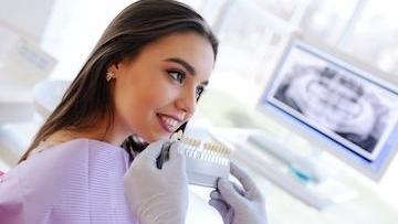 Dentist comparing teeth whitening shades