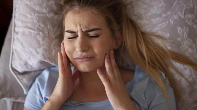 Woman suffering from TMJ pain