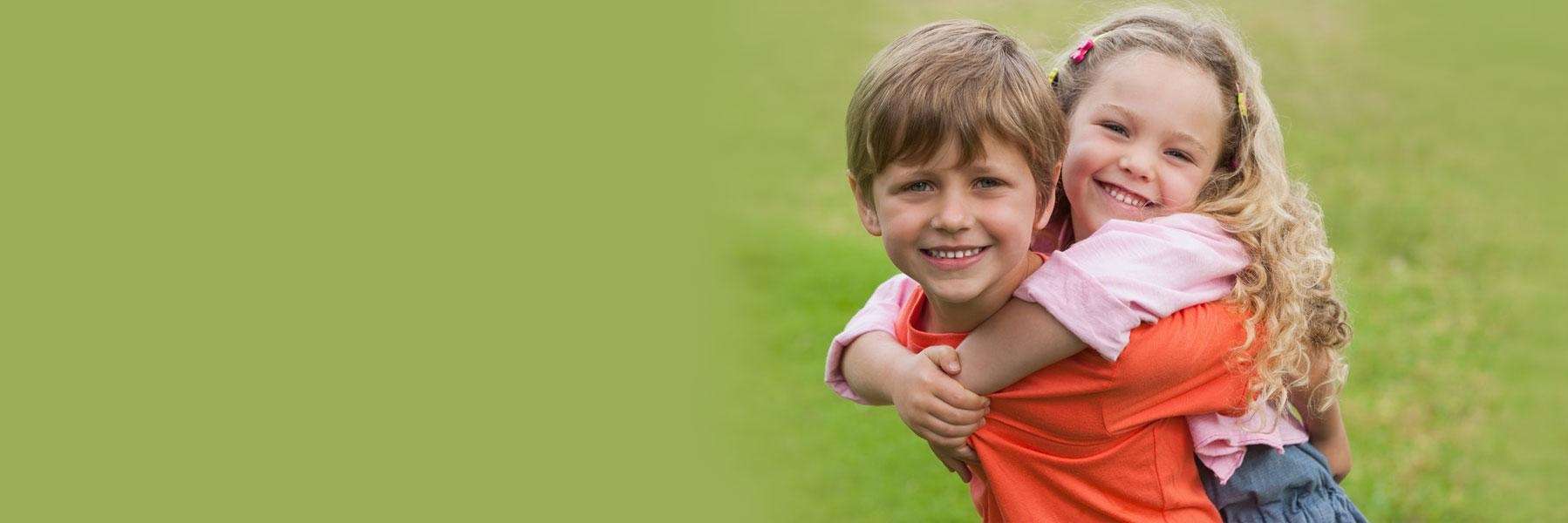 A sister and brother playing in a field