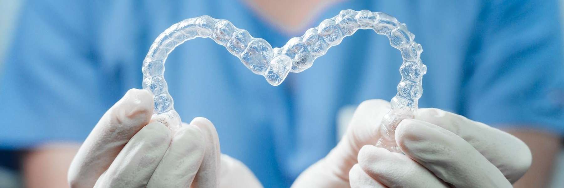 Two Invisalign trays in the shape of a heart | Jonesboro dentist